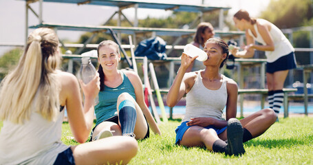 Sport, outdoor and women relax with water bottle, hydration and rest, field hockey athlete take...