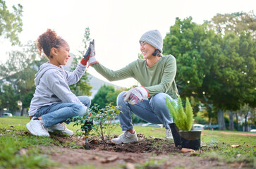 High five, child and woman with plant for gardening, ecology and agriculture in a park with trees....