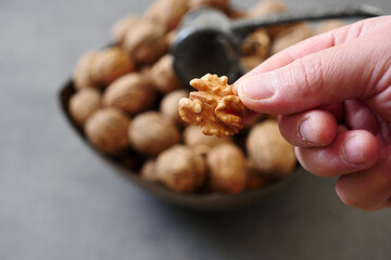 close-up,a bowl of dried walnuts in shell and cleaned walnut kernels,