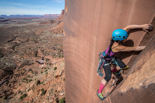 Side view of woman climbing rock, Utah, USA