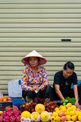 Asian women selling fruit in the market. Vietnamese. Fruit store. local life