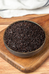 Black hot pepper spice in bowl. Chili pepper is a hot spice obtained by drying the pepper in the sun. Dry spice concept. local name isot. close up