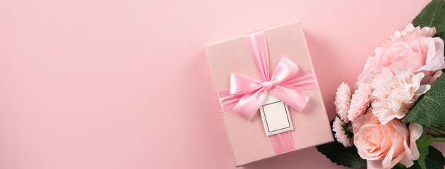 Valentine's Day and Mother's Day design concept background with pink flower and gift on pink background.