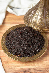 Black hot pepper spice in bowl. Chili pepper is a hot spice obtained by drying the pepper in the sun. Dry spice concept. local name isot. close up