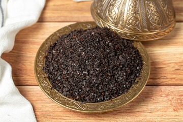 Black hot pepper spice in bowl. Chili pepper is a hot spice obtained by drying the pepper in the sun. Dry spice concept. local name isot. close up