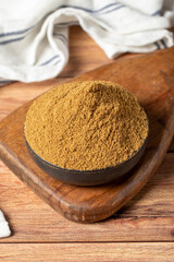 Powdered cumin spice. Cumin spice in bowl on wooden background. Dry spice concept. close up