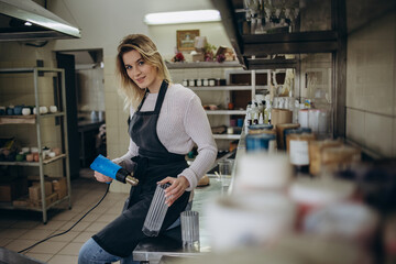 the concept of making a candle. a woman dries a mold for a candle