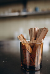 Woman making aromatic candles at wooden table, closeup