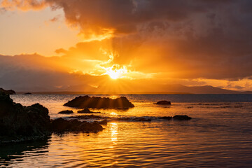 Fototapeta na wymiar Sunrise from rhoscolyn Beach looking to Snowdonia