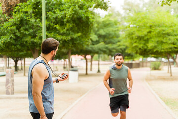 Coach training an hispanic runner