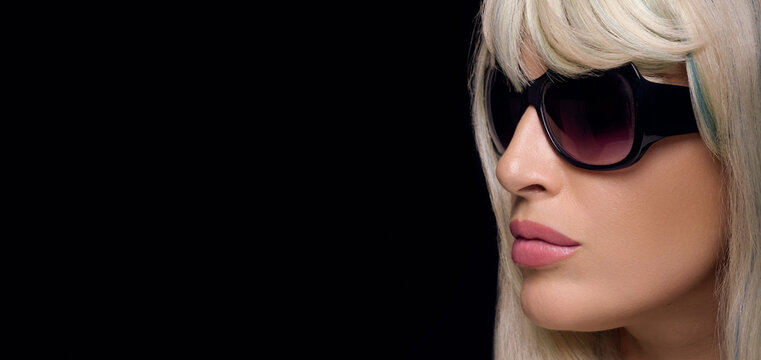 Beautiful blond woman in sunglasses. Fashion women eyewear panorama banner isolated on black background.