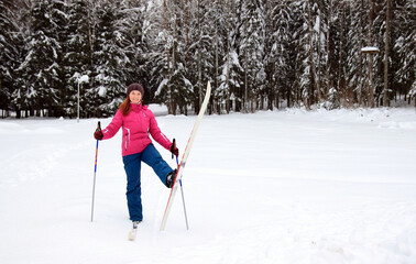 a woman with skis in winter