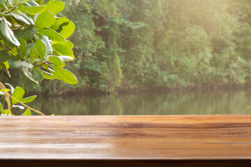 empty wooden table with lake background	