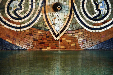Fototapeta na wymiar Mosaic ornament on the wall of old baths in Tbilisi.