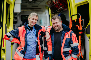 Portrait of rescuers in front of ambulance car.