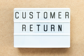Lightbox with word customer return on wood background