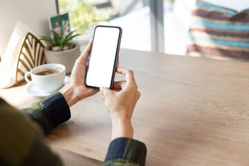 cell phone blank white screen mockup.hand holding texting using mobile on desk at office.background empty space for advertise.work people contact marketing business,technology