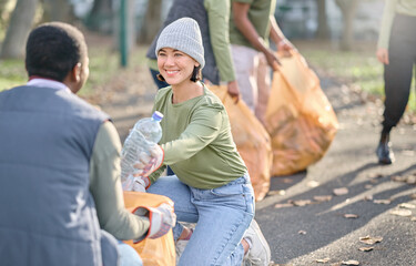 Volunteer, community service and people cleaning plastic in park with garbage bag. Happy woman and...