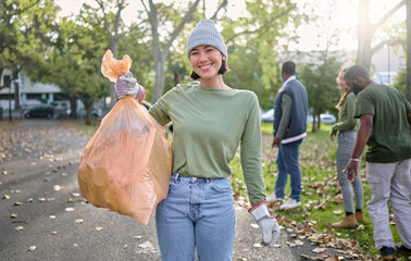 Plastic bag, park and happy woman in cleaning portrait for earth day, community service or...