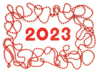 Red felt new year numbers 2023 on white background. Red beads around like frame. Valentine's Day concept.