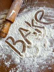 The inscription "Bake" flour on scattered white flour