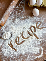 The inscription  "recipe" flour on scattered white flour