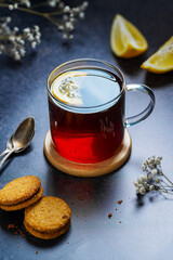 Black tea in glass cup, hot traditional tea with cookies