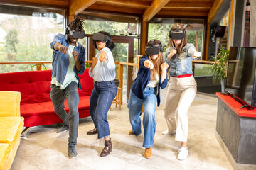Group of young people playing with virtual reality and visor, gamers in action while doing martial arts with headset, new technologies applied in a playful way, home entertainment