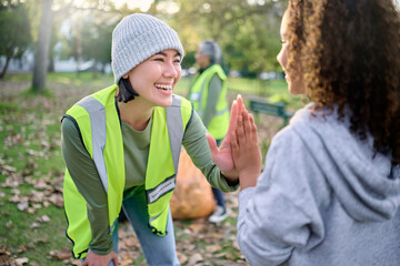High five, volunteer woman and child cleaning garbage pollution, waste product or community...