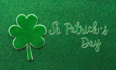Happy St Patrick's Day decoration concept made from shamrocks ( clover leaf) and the text on green...