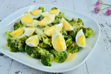 Broccoli salad with boiled egg served with mustard mayonnaise sauce dressing