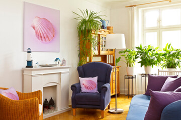Customizable home decoration concept: living room with a square canvas print of a pink shell picture and a throw pillow of the same on wingback chair.