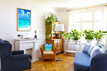 Custom-made home decoration concept: colorful living room with a framed print of a seascape photo and a throw pillow of the same picture.