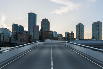 Fototapeta na wymiar Empty urban asphalt road exterior with city buildings background. New modern highway concrete construction. Concept of way to success. Transportation logistic industry fast delivery. Boston. USA.