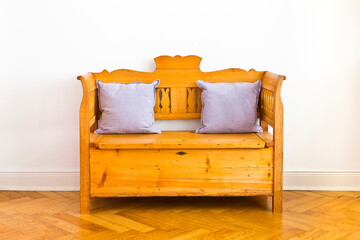 Antique wooden chest bench with 2 pillows, storage space unter the seat, circa 1880, against the...