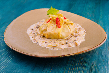 Pancakes rolled into a bag and stuffed with fried mushrooms