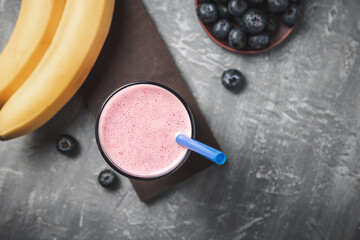 Blueberry and banana smoothie drink in a glass, top view, healthy eating concept
