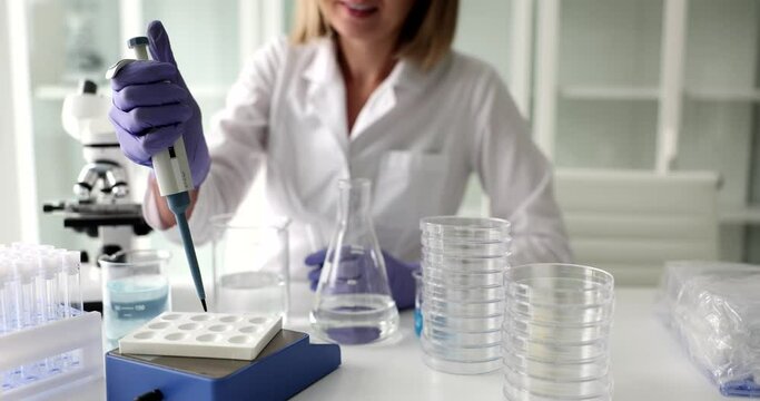 Scientist analyzes te liquid with pipette to extract toxins from samples