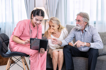 Caregiver nurse use tablet pc advise elderly couple to senior woman and man at home