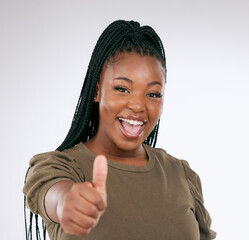 Black woman, portrait smile and thumbs up for winning, discount or deal isolated on a grey studio...