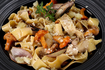 Exclusive main course - pasta with chanterelle mushrooms. Close up from top. © ABF_MATEO