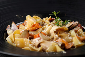 Exclusive main course - pasta with chanterelle mushrooms. Close up.