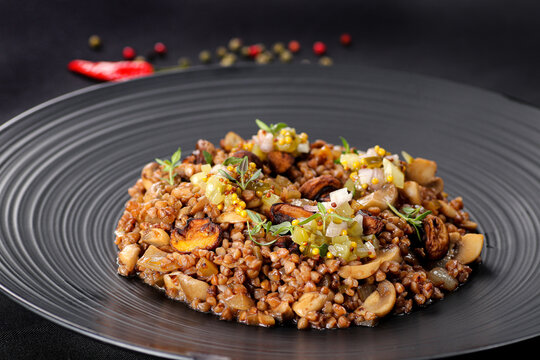 Exclusive main course - groats with mushrooms. Close up. 