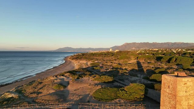 hermoso amanecer en la playa de Cabopino y las dunas de Artola junto a torre ladrones, Marbella