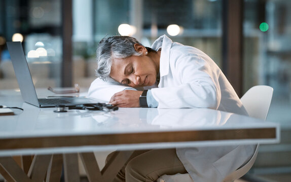 Woman Doctor Sleeping At Desk In Overtime Medical Office, Late Hospital And Burnout. Stress, Night And Healthcare Worker Nap At Table With Fatigue, Tired Job And Mental Health Problem From Overworked