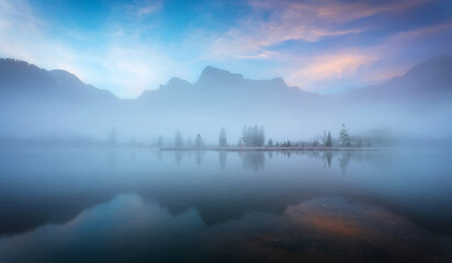 Fabulous misty morning scene of nature. View of Forest lake, Almsee lake in highland with rocky...