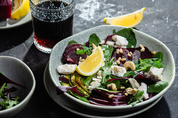 Salad with beets and goat cheese on a dark background