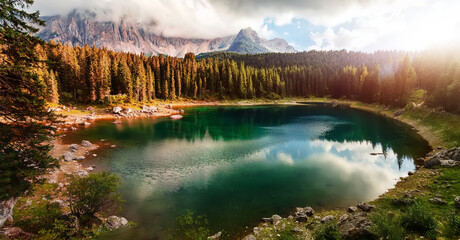 Amazing nature landscape. Lago di Carezza lake or The Karersee with reflection of mountains in the dolomite alps, Dolomites, Tyrol, Italy. Concept of ideal resting place. Popular travel destination.