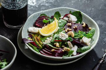 Salad with beets and goat cheese on a dark background