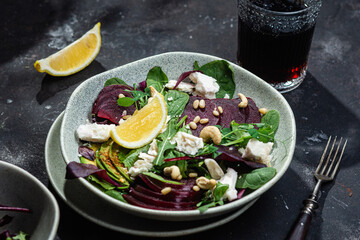 Salad with beets and goat cheese on a dark background